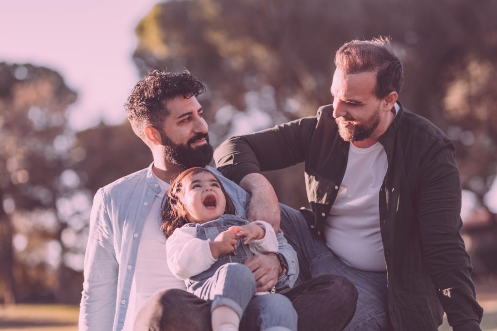 Gay intended parent with child from surrogacy
