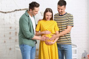 Gay_Couple_With_Pregnant_Surrogate_Mother_At_Home
