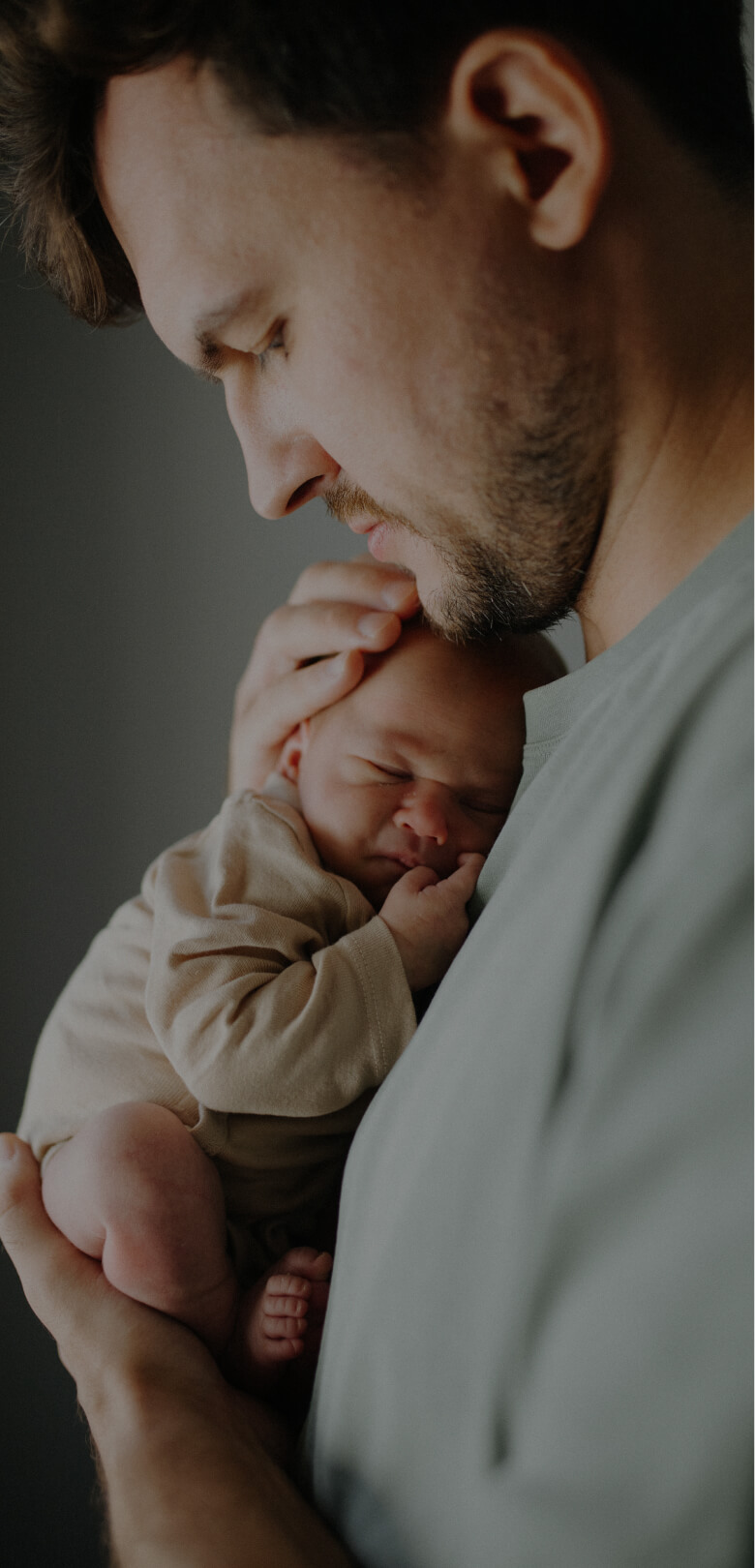 Split photo of a young girl looking happy and a young father holding his newborn baby against his chest, looking down at his baby.